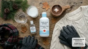 Flat lay of Canadian winter essentials including a cozy sweater, gloves, and a hydrating facial cleanser for dry skin.