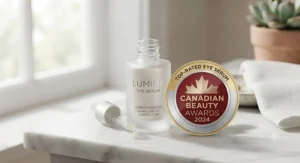A top-rated best eye serum bottle resting beside a Canadian beauty award badge.